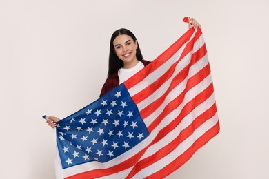 Photo of 4th of July - Independence Day of USA. Happy woman with American flag on white background