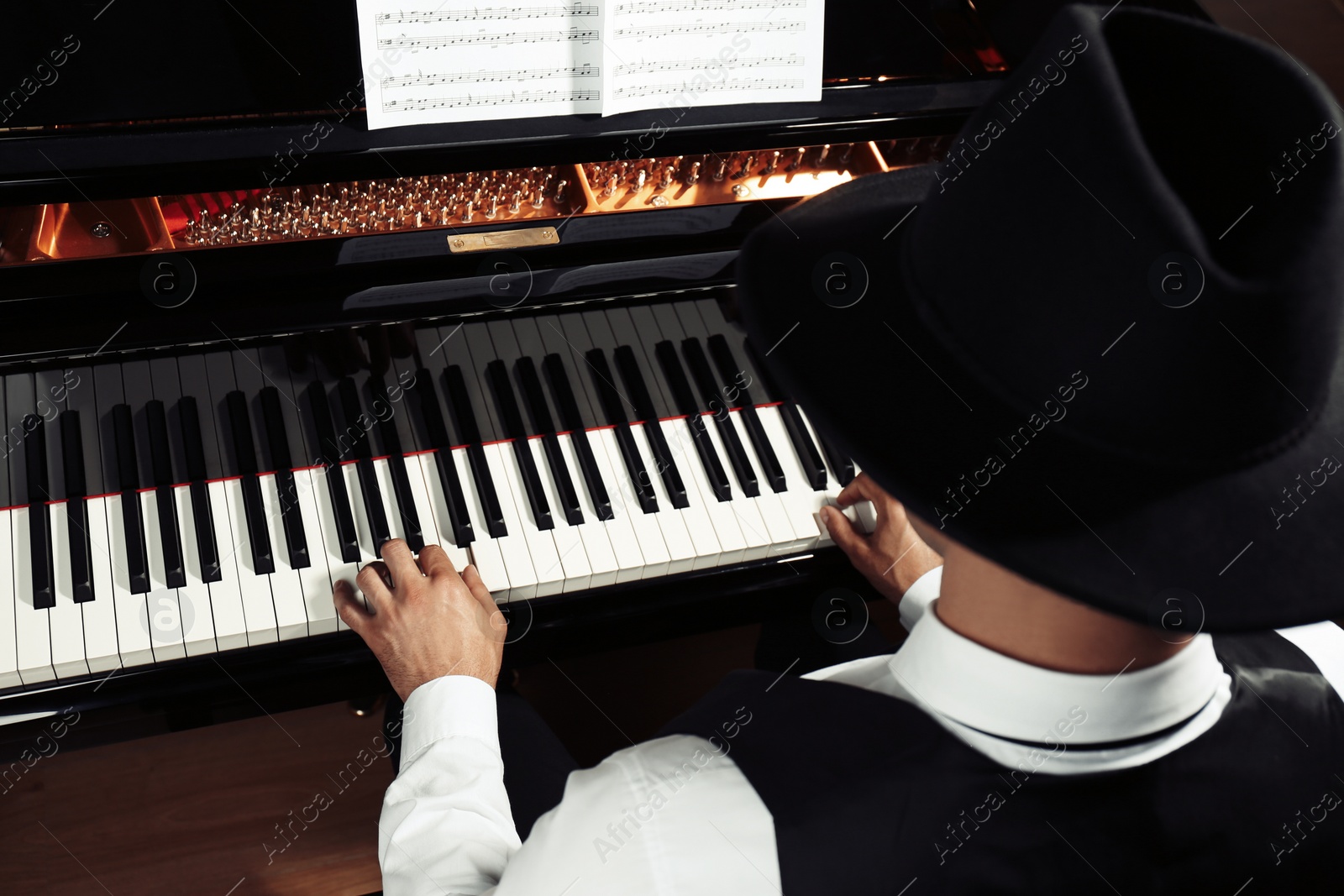 Photo of Man playing piano, above view. Talented musician