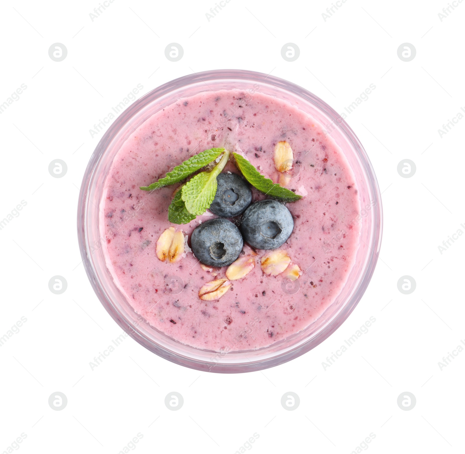 Photo of Glass of tasty blueberry smoothie with oatmeal on white background, top view