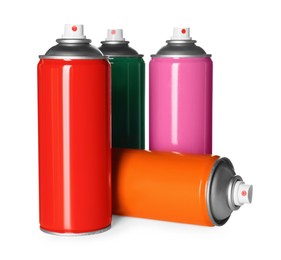 Photo of Colorful cans of spray paints on white background