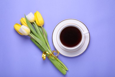 Cup of coffee and beautiful tulips on light purple background, flat lay
