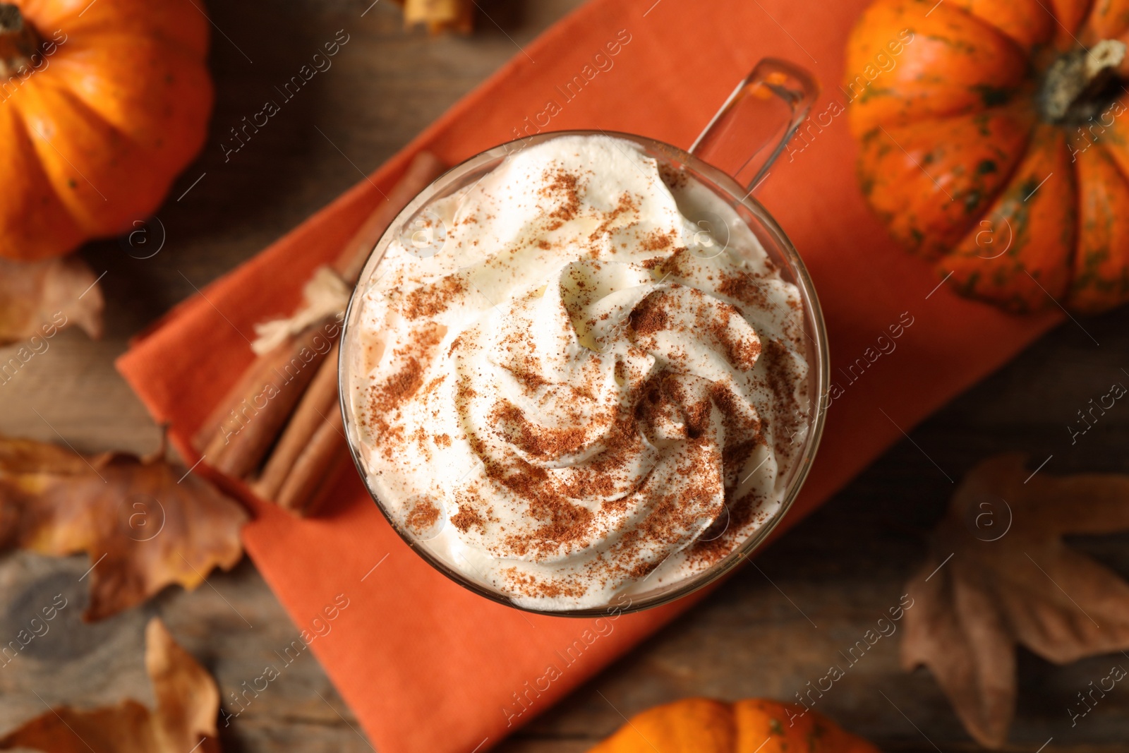 Photo of Delicious pumpkin latte on table, top view