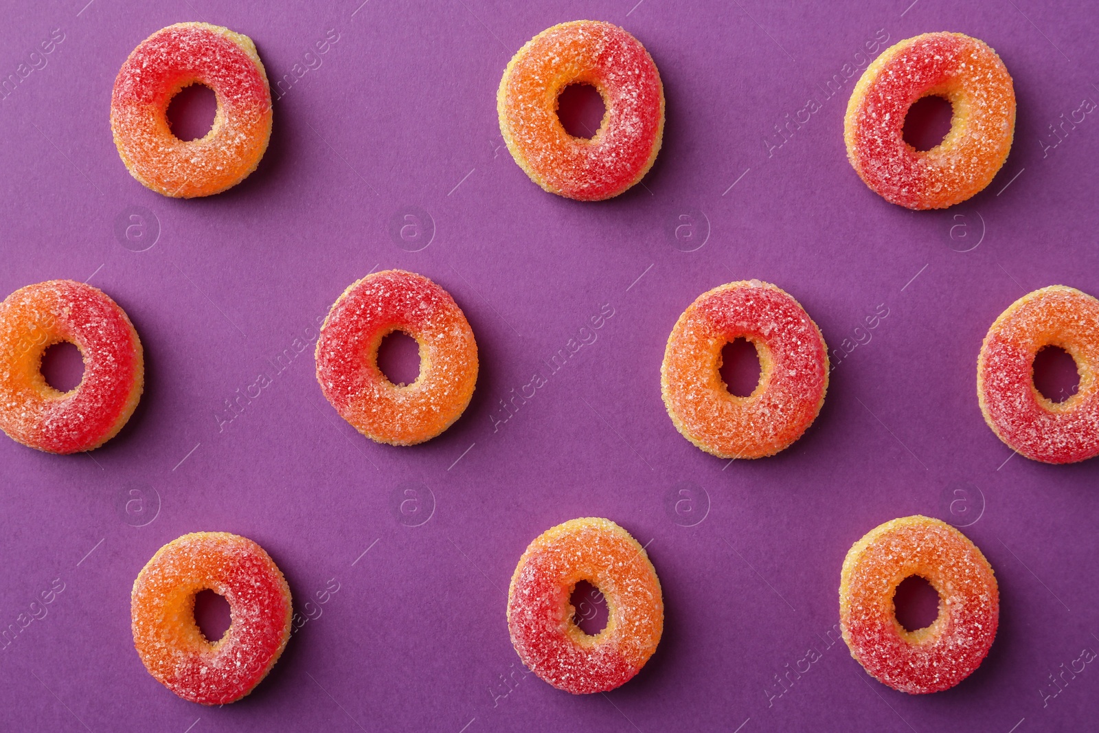 Photo of Flat lay composition with delicious jelly candies on color background