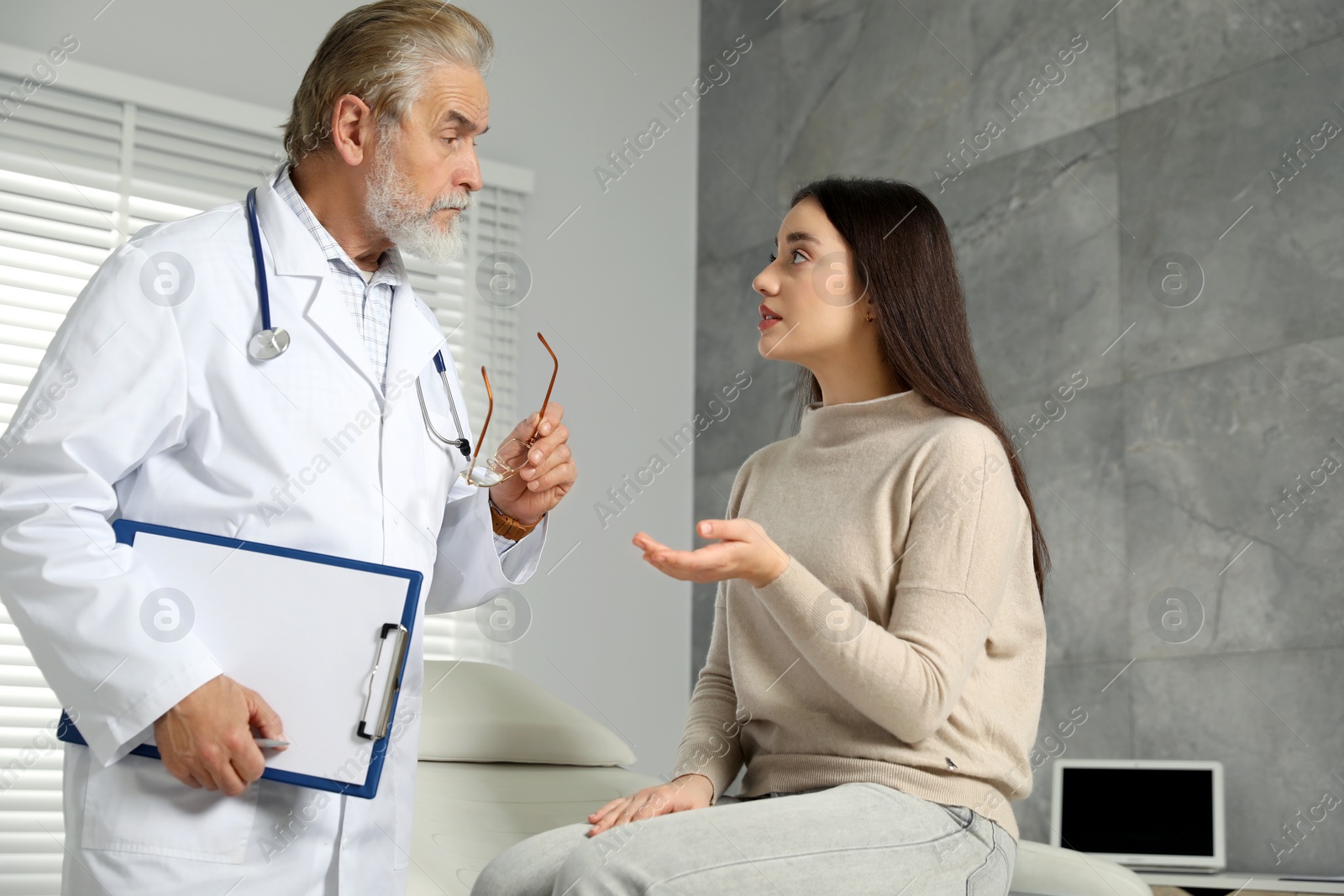 Photo of Patient having appointment with senior doctor in clinic