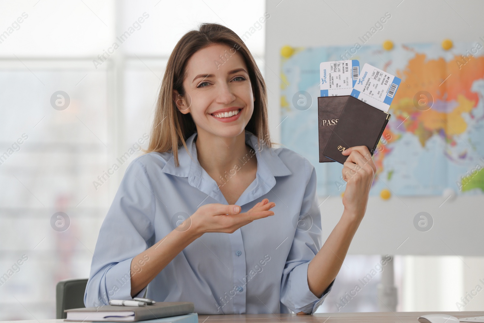 Photo of Travel agent with tickets and passports in office