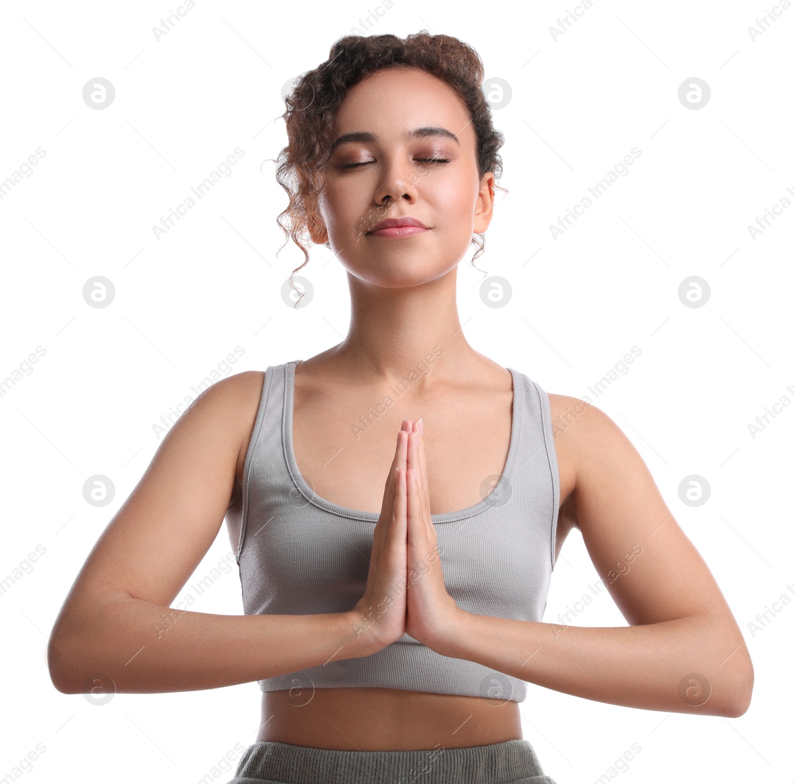 Photo of Beautiful African-American woman meditating on white background