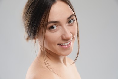 Portrait of beautiful woman on grey background