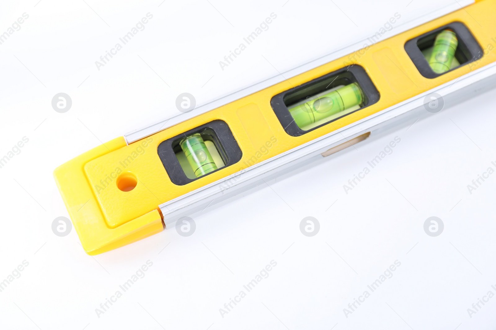 Photo of Yellow building level isolated on white. Construction tool