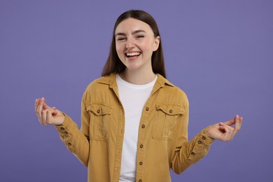 Photo of Happy woman showing money gesture on purple background