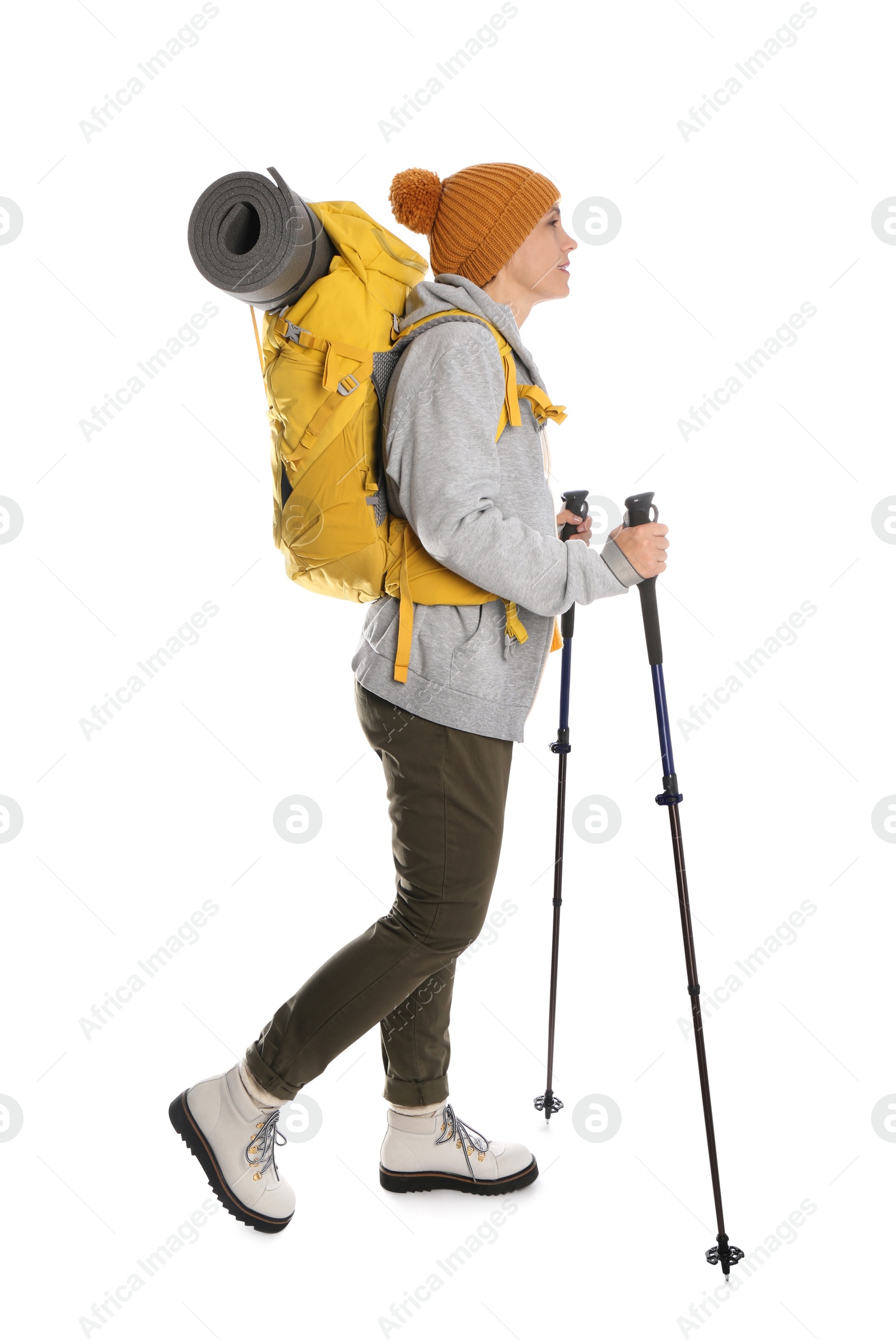 Photo of Female hiker with backpack and trekking poles on white background