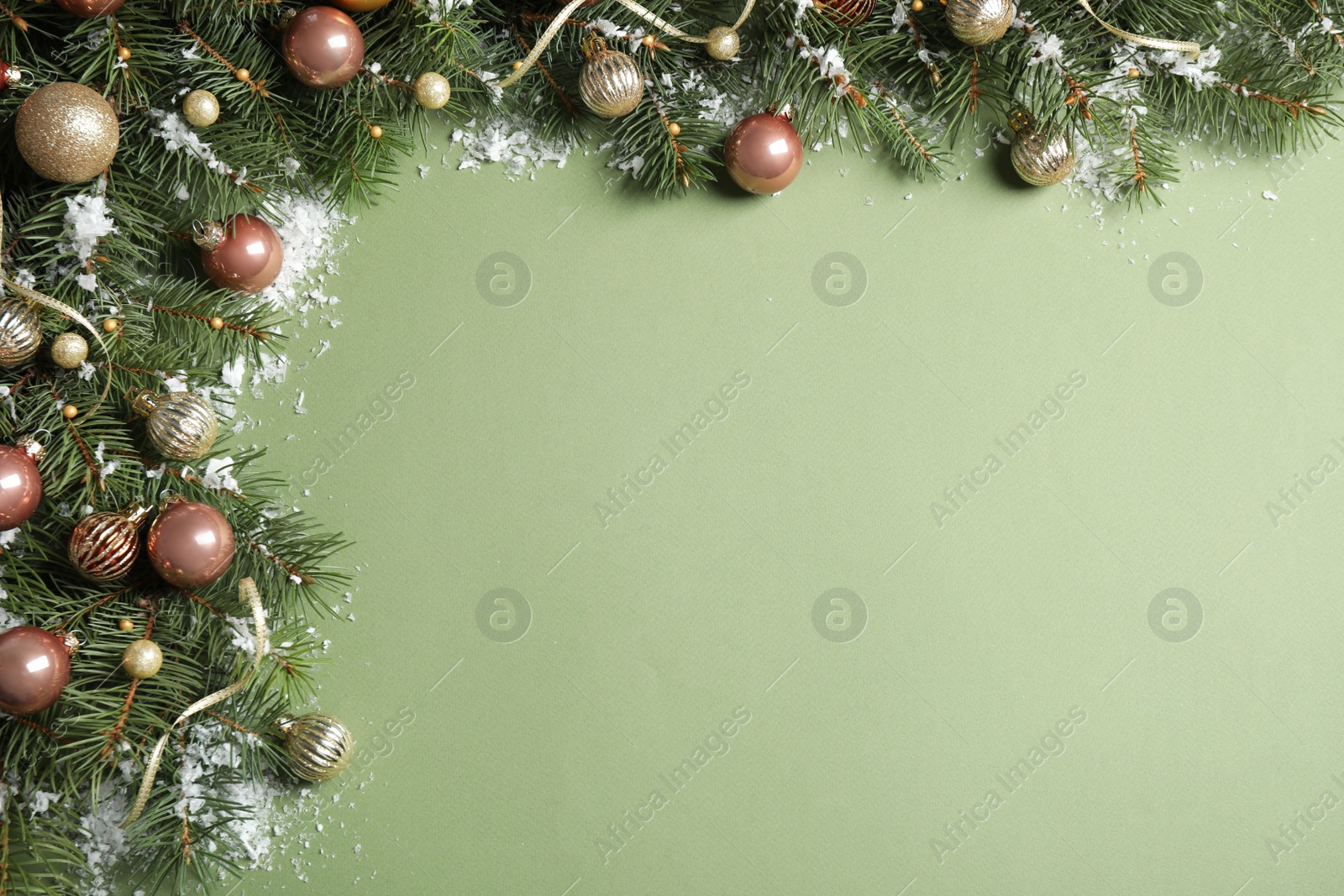Photo of Fir tree branches with Christmas decoration on green background, flat lay. Space for text