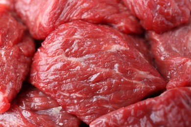 Pieces of raw beef meat as background, closeup