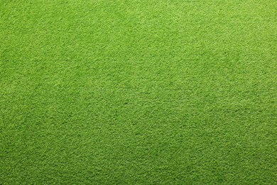 Photo of Green artificial grass as background, top view