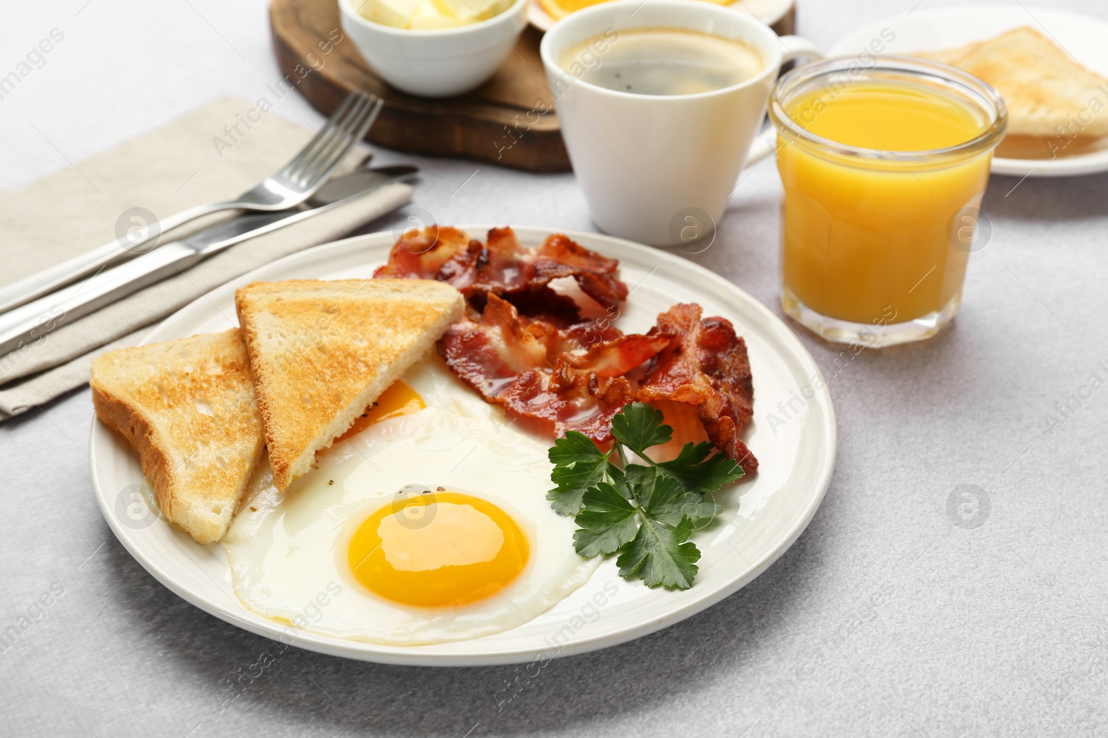 Photo of Delicious breakfast with sunny side up egg served on light table