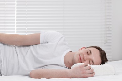 Photo of Man sleeping on orthopedic pillow at home