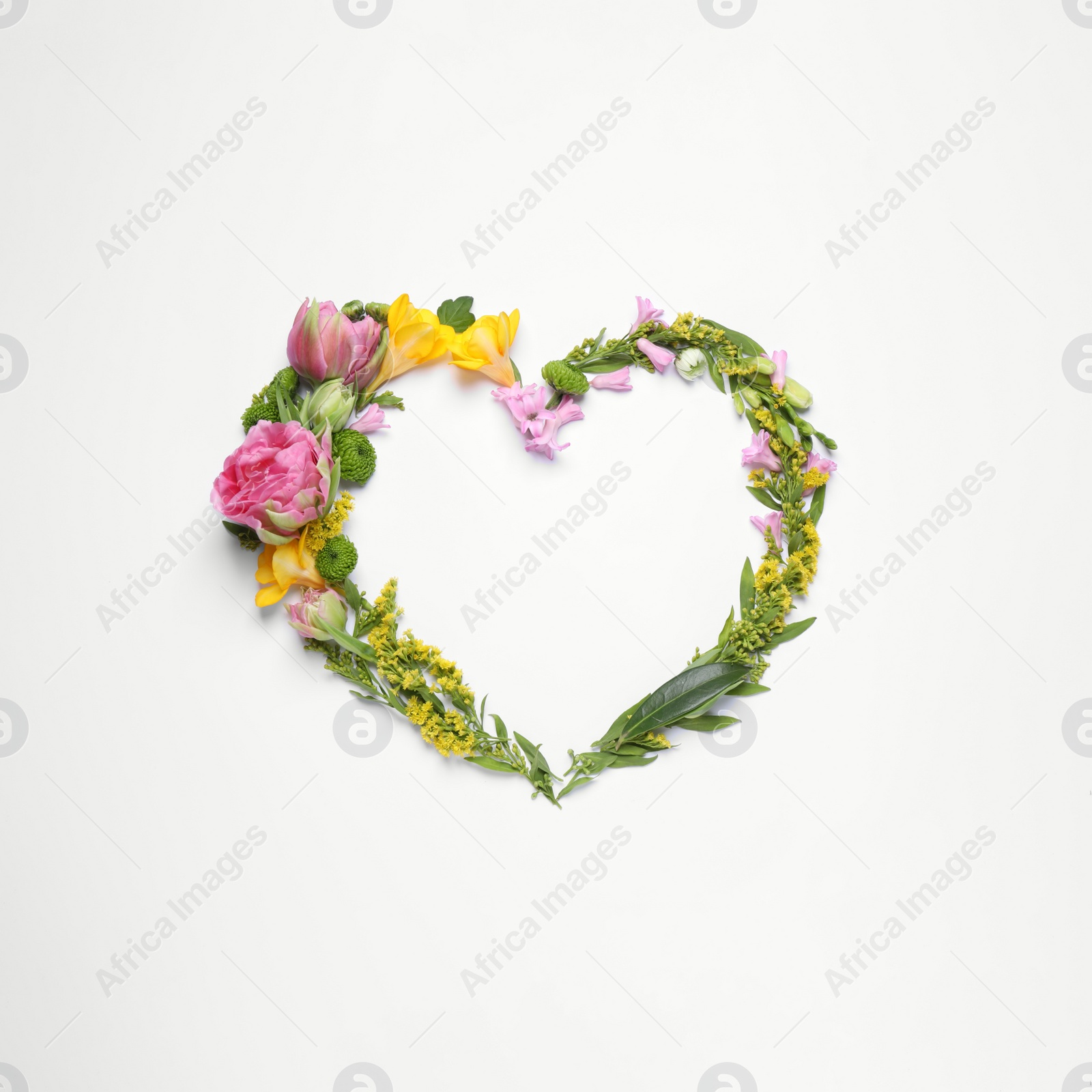 Photo of Beautiful heart made of different flowers on white background, top view