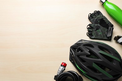 Photo of Flat lay composition with different cycling accessories on wooden background, space for text