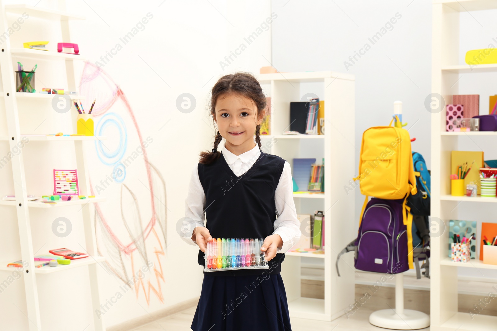 Photo of Cute child choosing school stationery in store