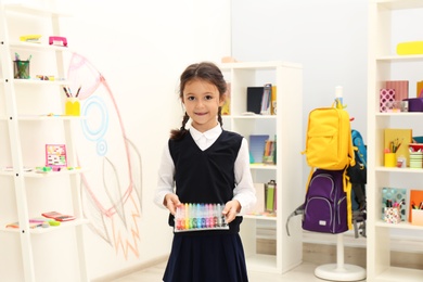 Cute child choosing school stationery in store