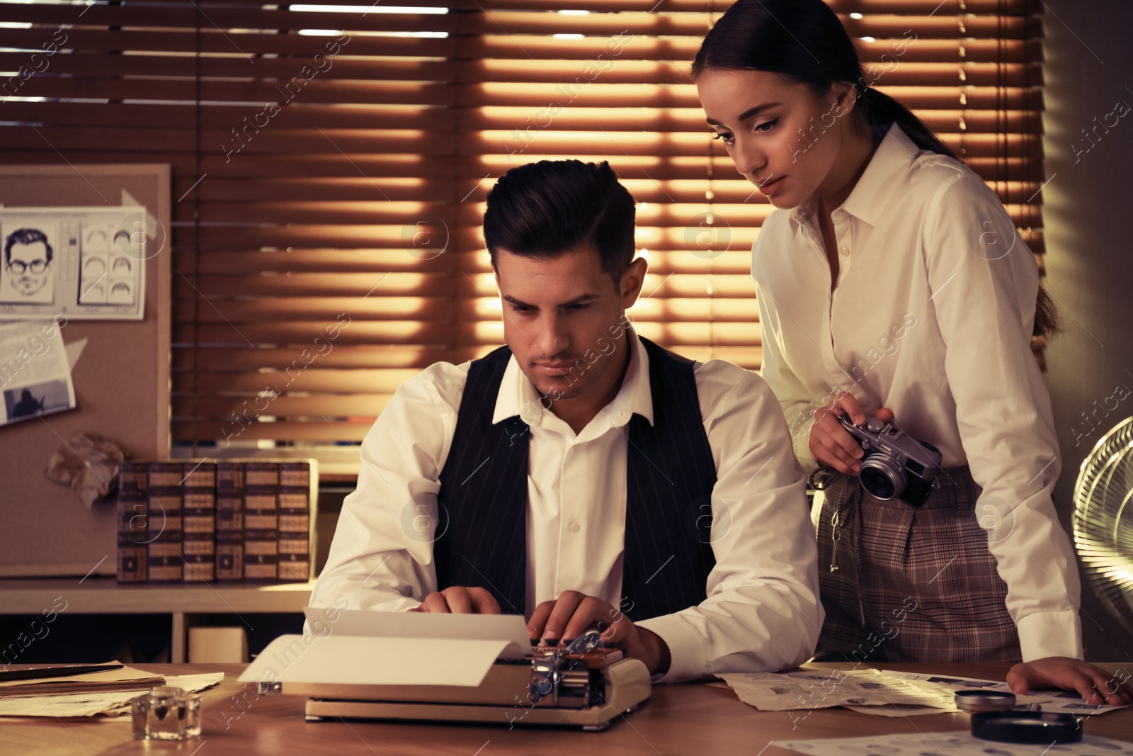 Photo of Old fashioned detective and his colleague working in office