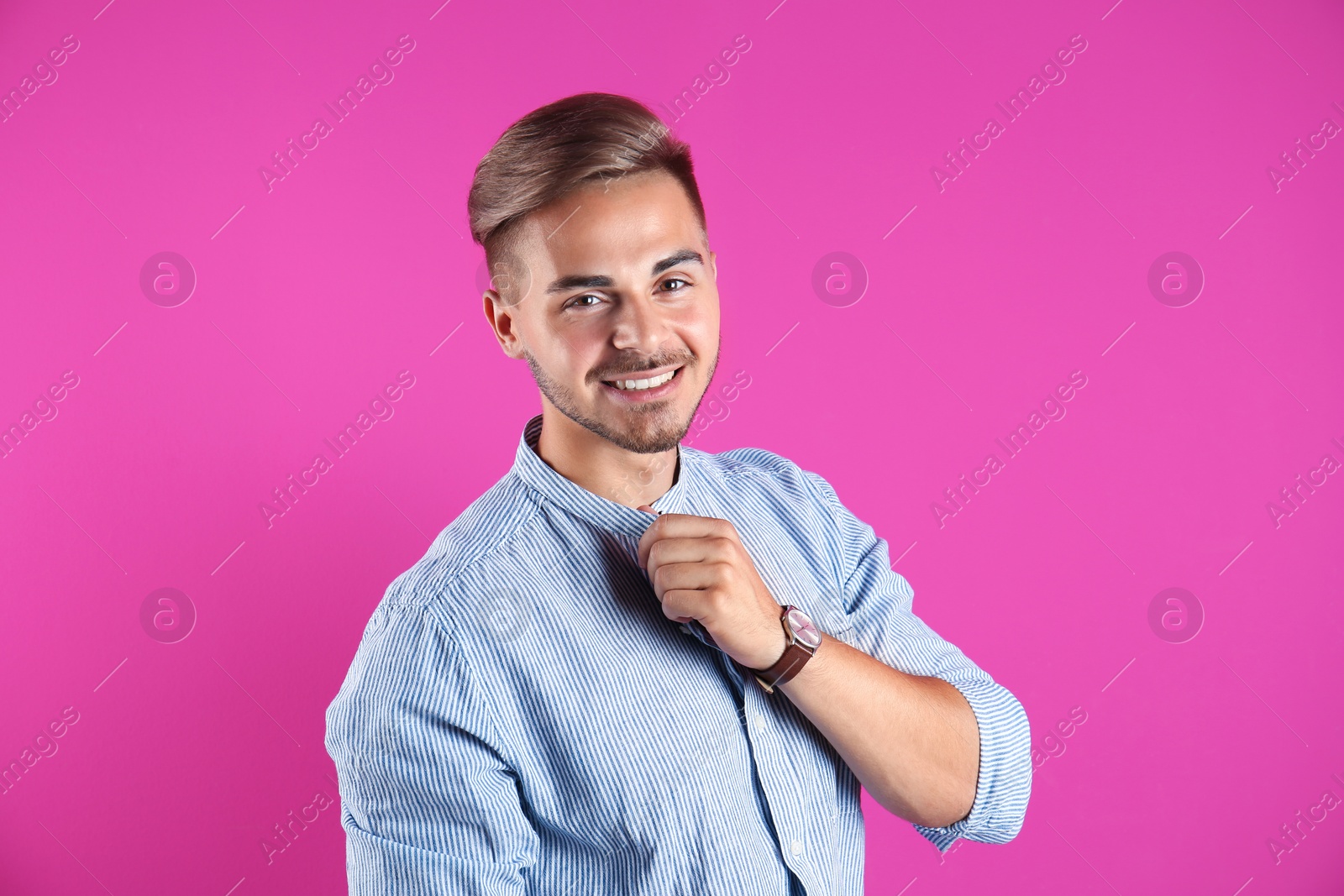 Photo of Young man with trendy hairstyle on color background