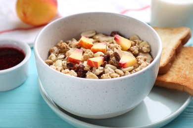 Muesli with peaches on light blue wooden table. Healthy breakfast