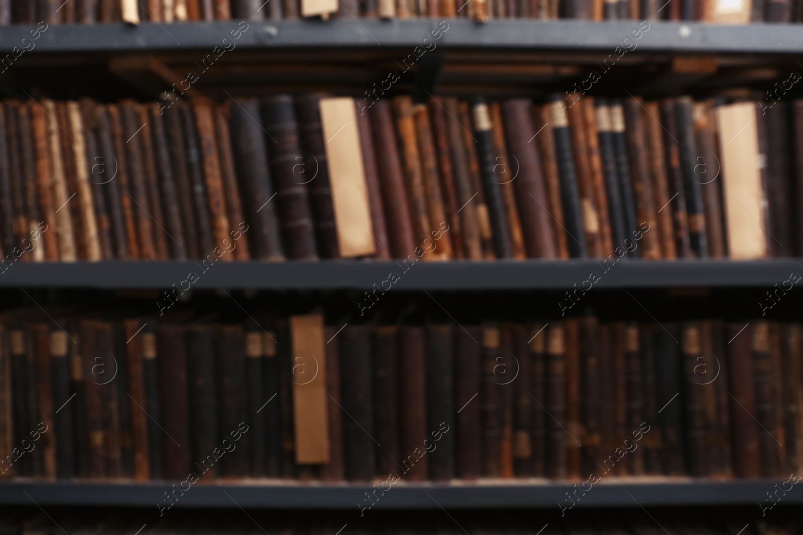 Photo of Blurred view of different books on shelves in library