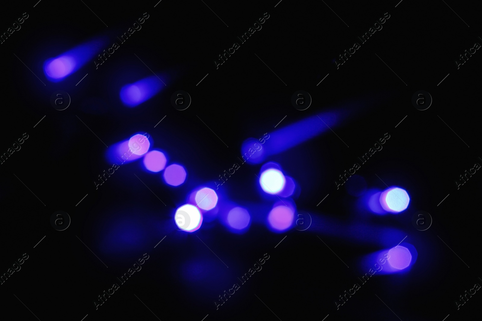 Photo of Beautiful colorful lights on dark background. Bokeh effect