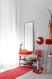 Photo of Cozy stylish hallway interior with shoe rack and mirror. Home design idea