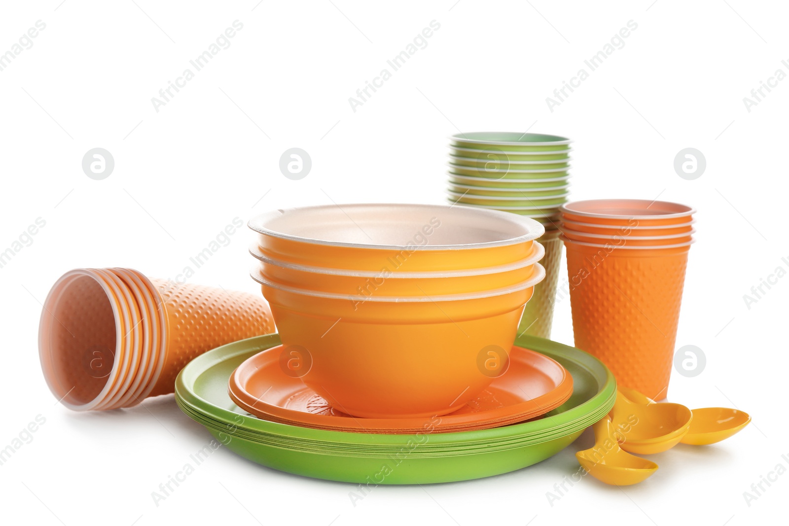 Photo of New plastic dishware on white background. Table setting