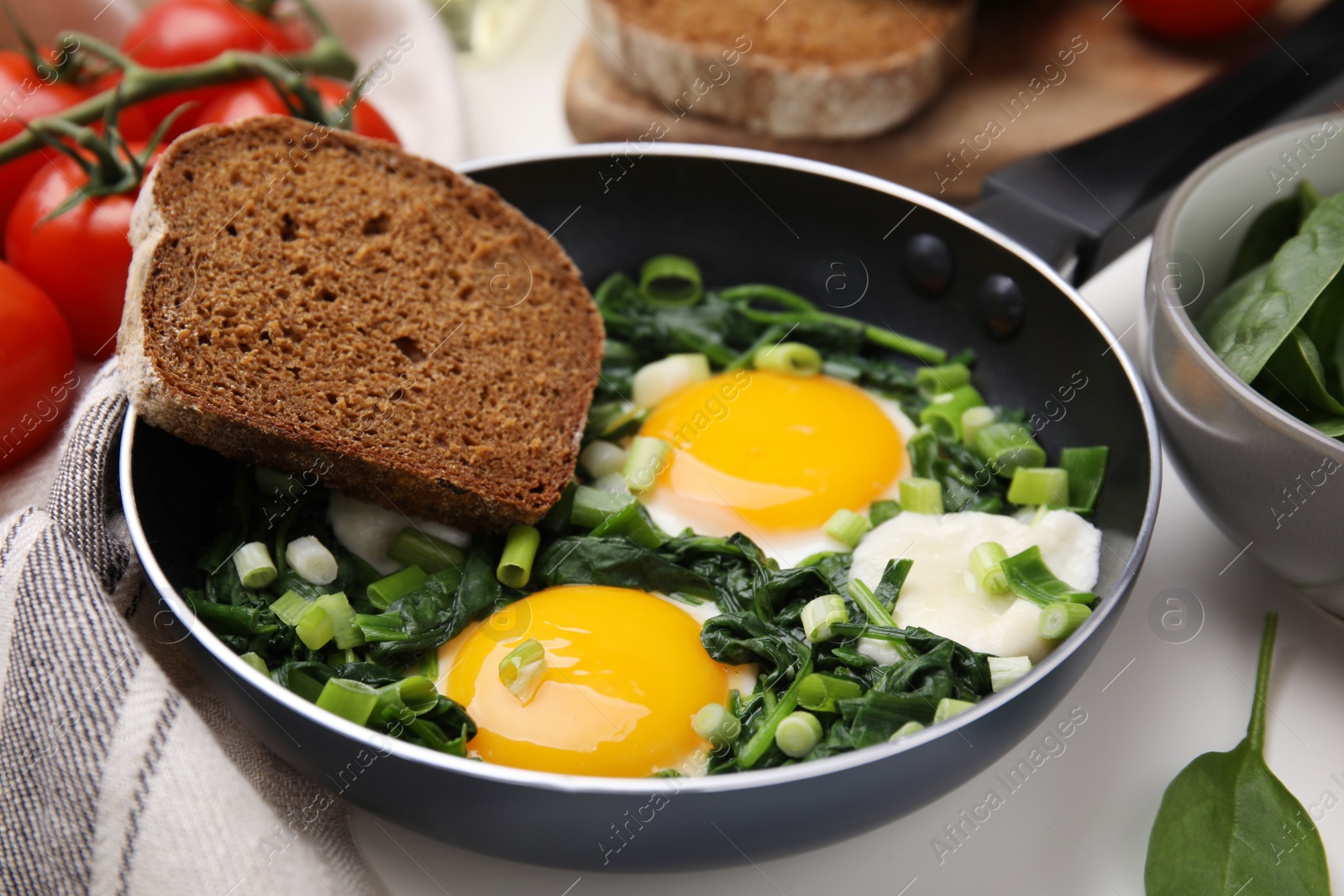 Photo of Tasty green Shakshouka served on table, closeup