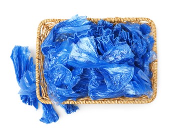 Basket with blue medical shoe covers isolated on white, top view