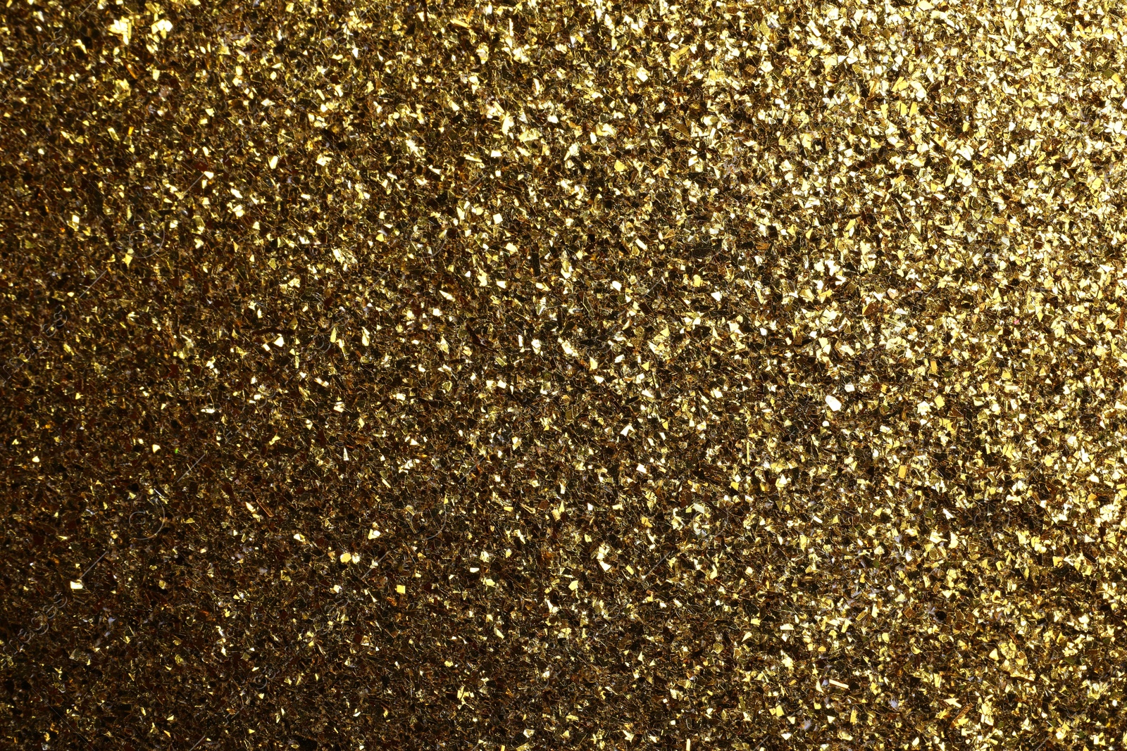 Photo of Beautiful shiny brass glitter as background, closeup