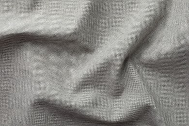 Photo of Texture of grey crumpled fabric as background, top view