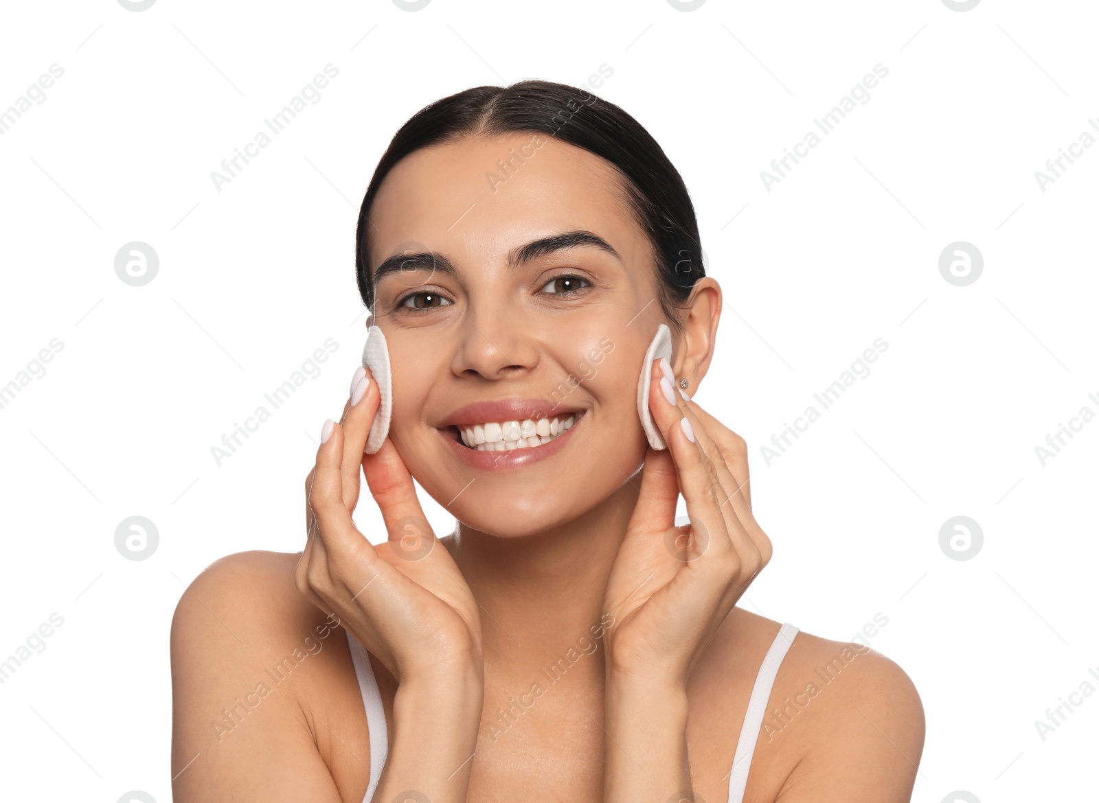 Photo of Young woman using cotton pads with micellar water on white background