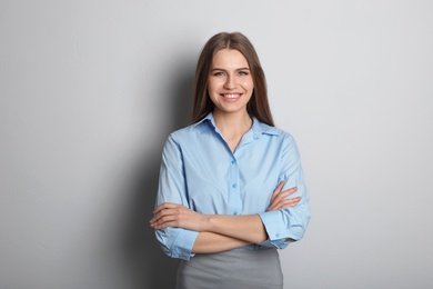 Photo of Beautiful real estate agent on grey background