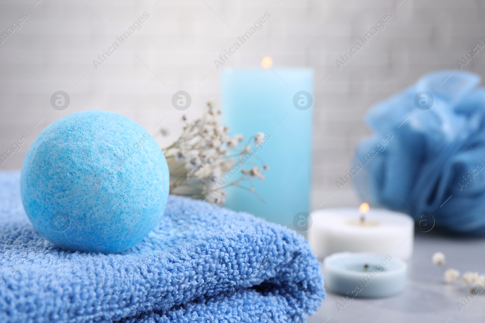 Photo of Beautiful aromatic bath bomb on towel, closeup. Space for text