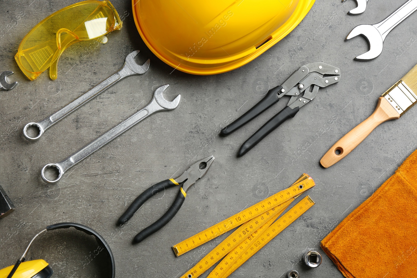 Photo of Flat lay composition with different construction tools on grey background