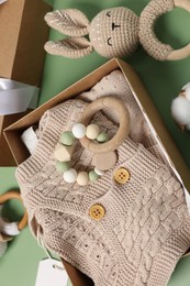 Photo of Flat lay composition with different baby accessories on green background