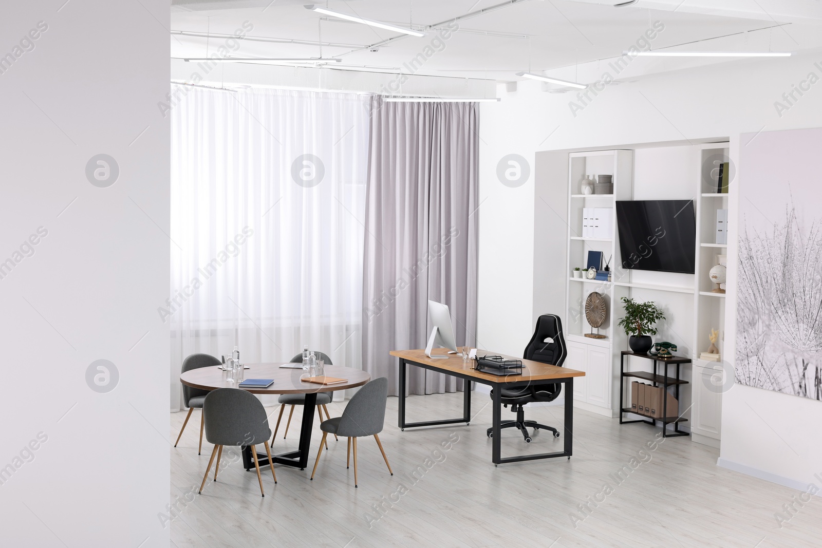 Photo of Stylish office with comfortable furniture and tv zone. Interior design