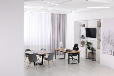 Stylish office with comfortable furniture and tv zone. Interior design