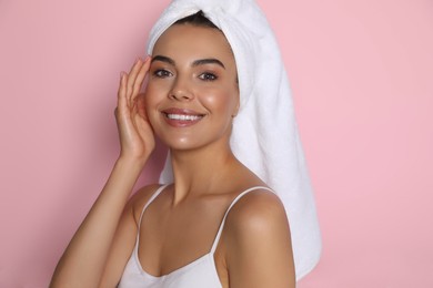 Photo of Beautiful young woman with towel on head against pink background