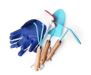 Photo of Pair of gloves and gardening tools on white background, top view