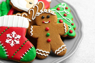 Photo of Tasty homemade Christmas cookies on light grey table, closeup