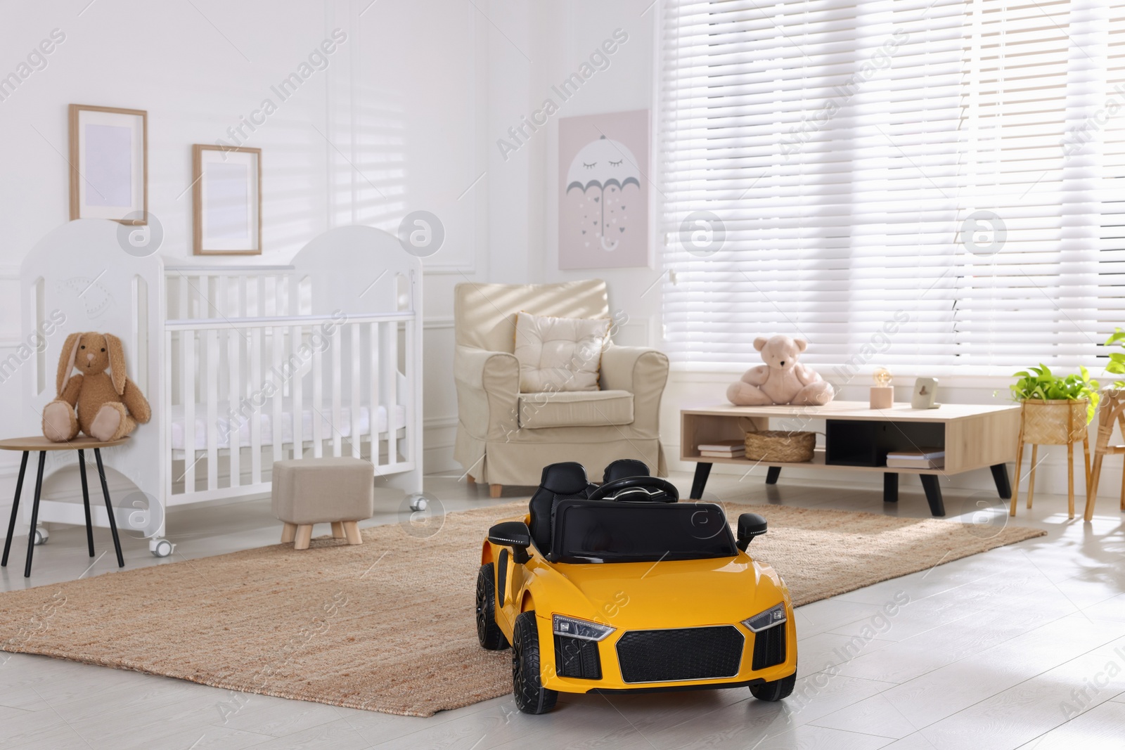 Photo of Yellow car in room at home. Child's toy