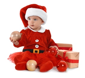 Photo of Festively dressed baby with gift boxes on white background. Christmas celebration