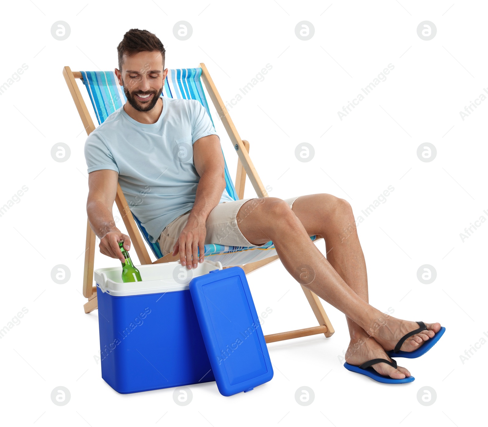 Photo of Happy man taking bottle of beer from cool box on white background