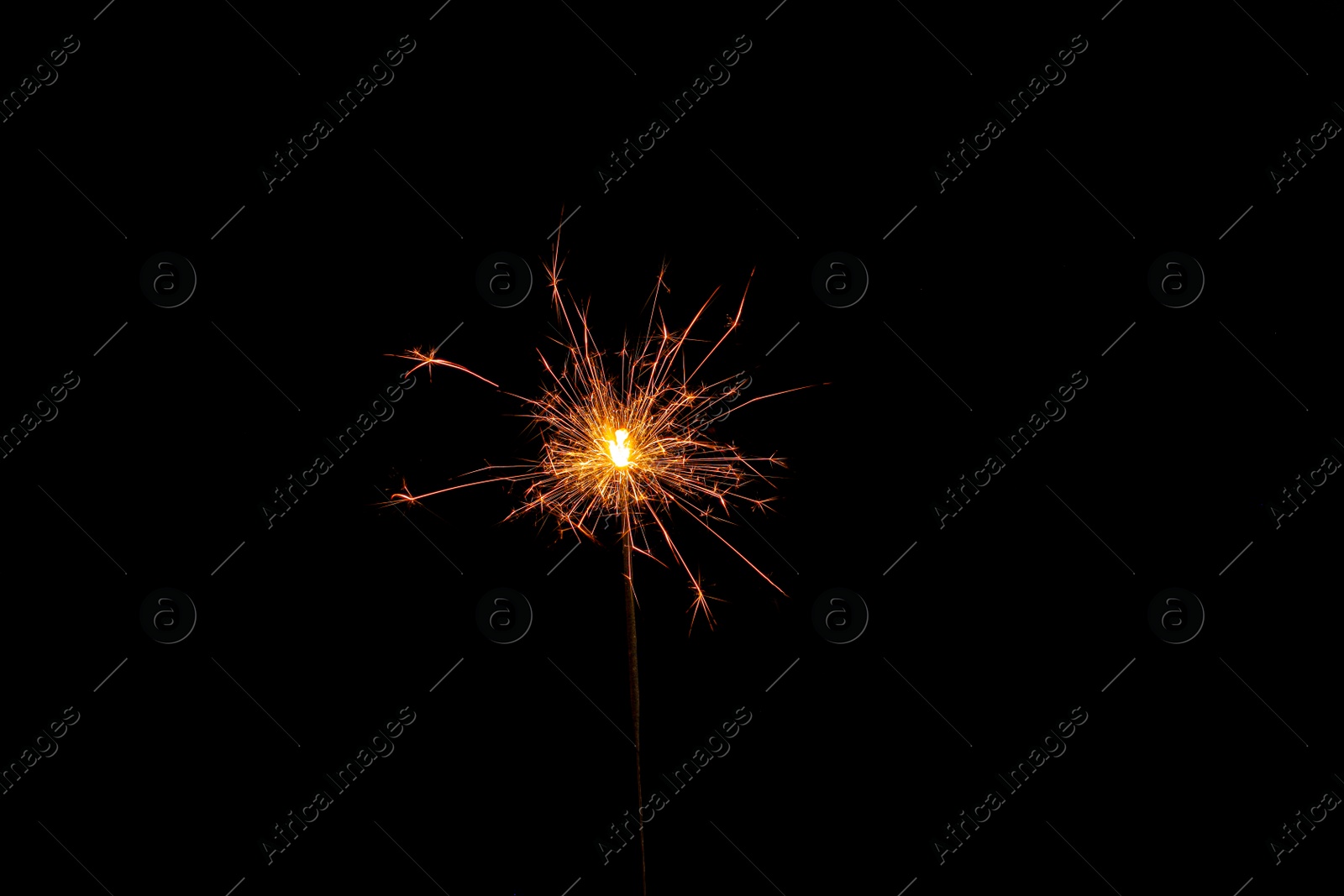 Photo of One burning sparkler stick on black background