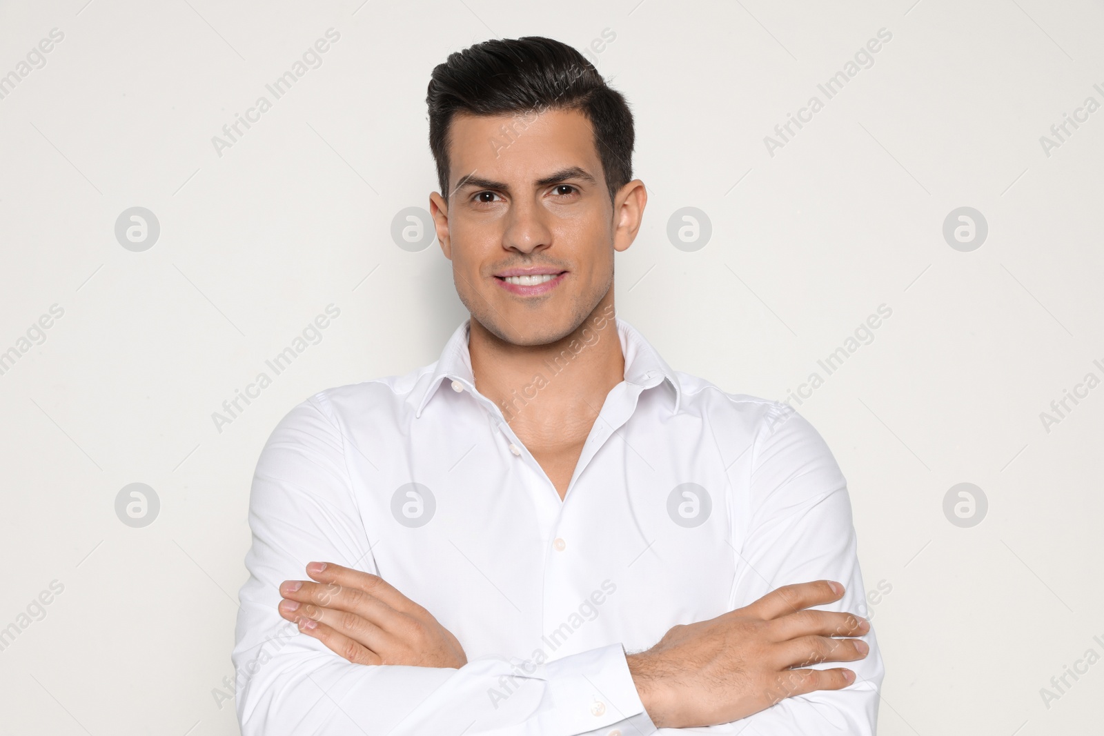 Photo of Portrait of handsome man smiling on light background