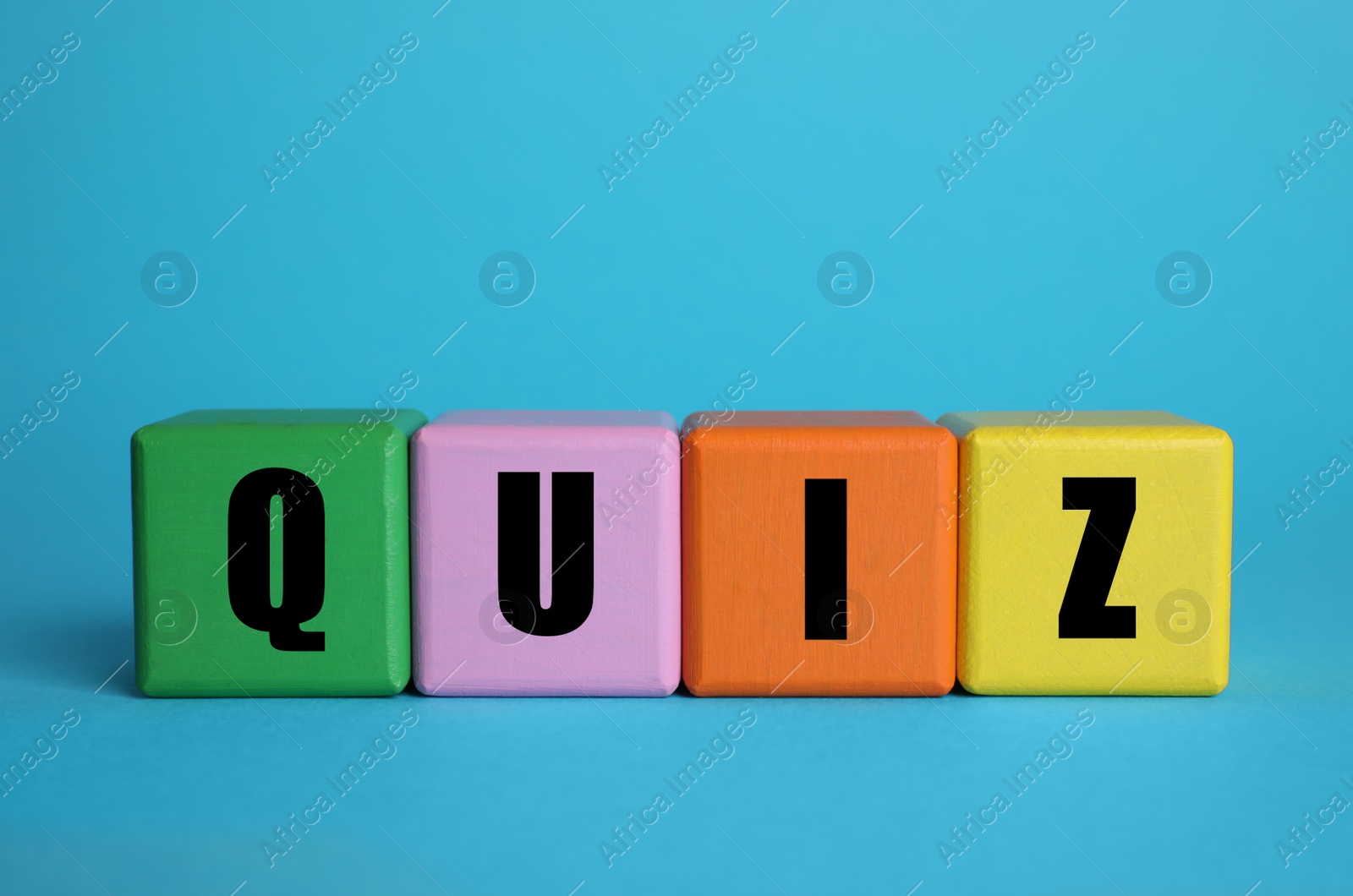 Photo of Colorful cubes with word Quiz on light blue background. Space for text
